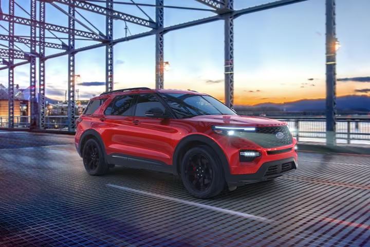 Red Ford Explorer driving on a bridge