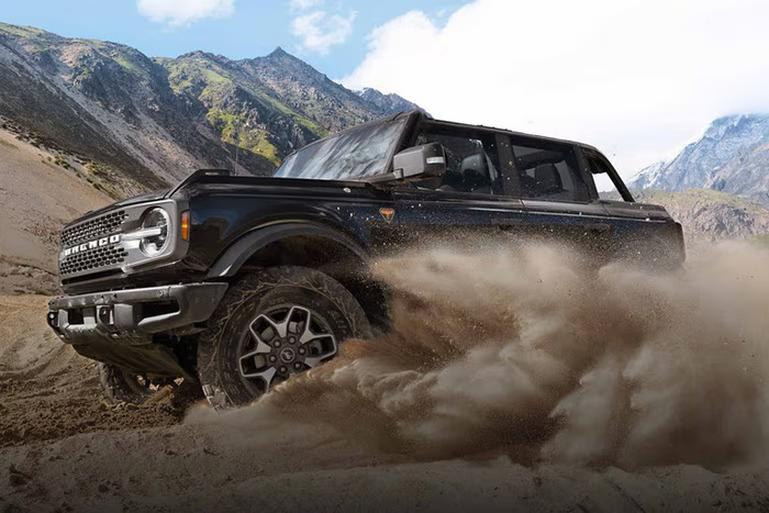 Black Ford Bronco driving in the sand