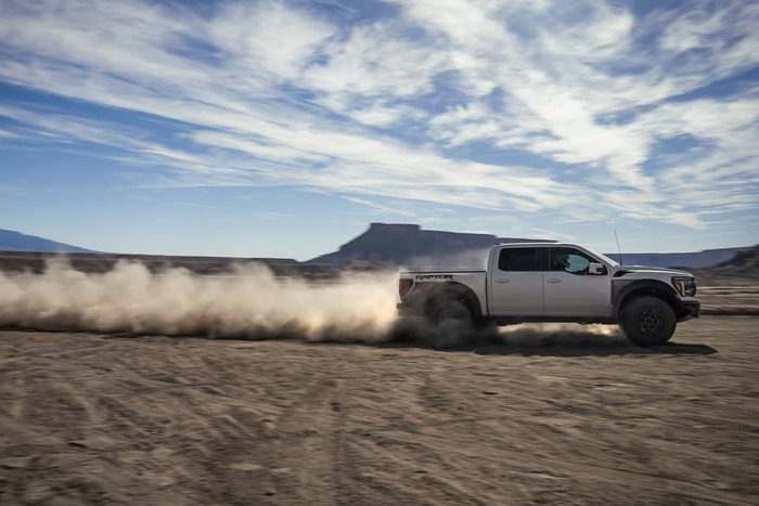 White Ford F-150 driving on dirt