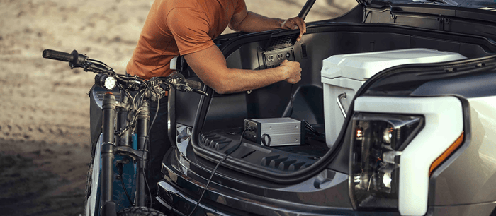 Man using outlet on 2025 Ford F-150 Lightning