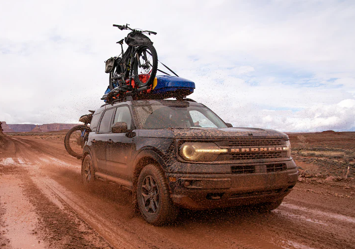 2025 Ford Bronco Sport with bike rack driving in mud